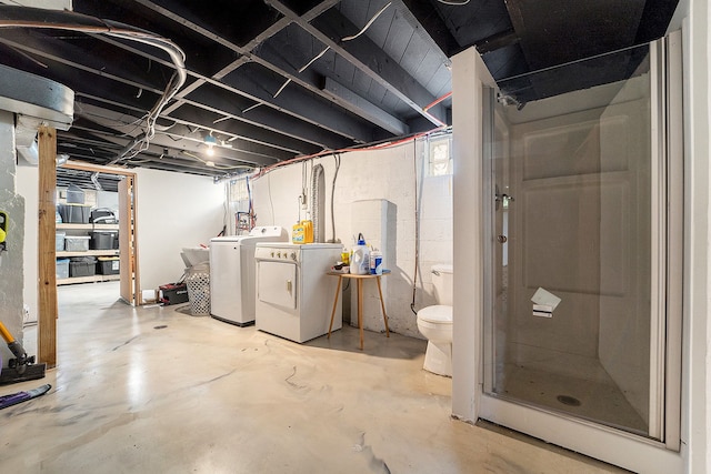unfinished basement featuring washing machine and clothes dryer