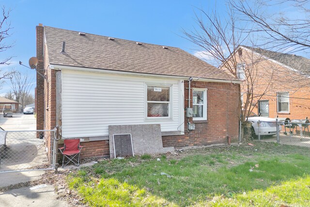 19544 Strasburg St, Detroit, MI 48205 - back of property with brick siding, fence, and a shingled roof