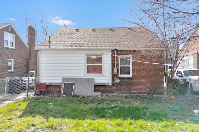 19544 Strasburg St, Detroit, MI 48205 - back of property with a shingled roof, fence, and a gate