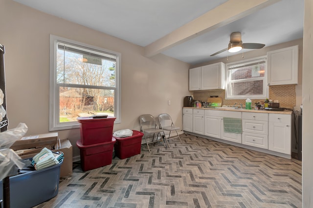 19544 Strasburg St, Detroit, MI 48205 - kitchen with backsplash, white cabinets, beamed ceiling, ceiling fan, and a sink