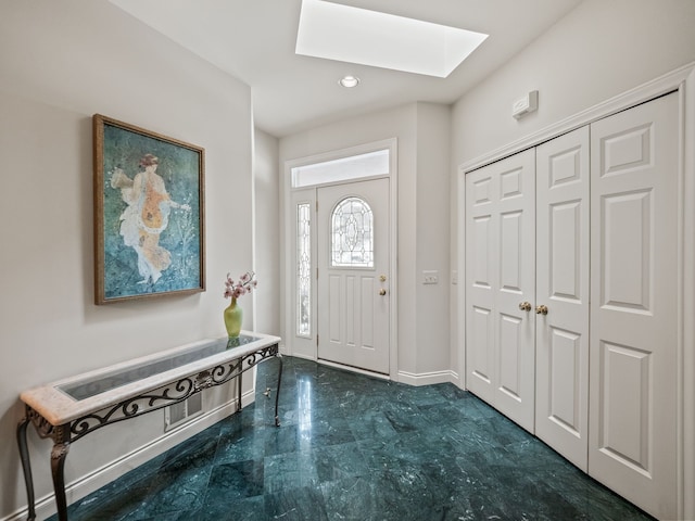 entrance foyer featuring recessed lighting, baseboards, and a skylight