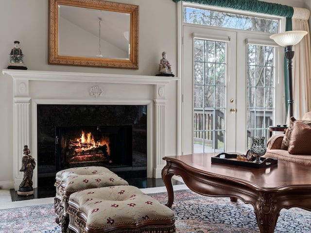 sitting room with french doors and a premium fireplace