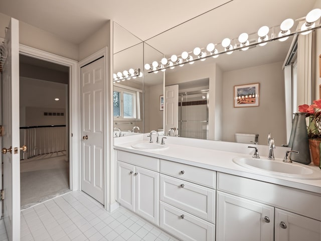 full bathroom with a shower stall, tile patterned floors, a sink, and toilet