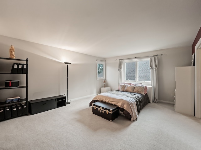 bedroom with baseboards and carpet