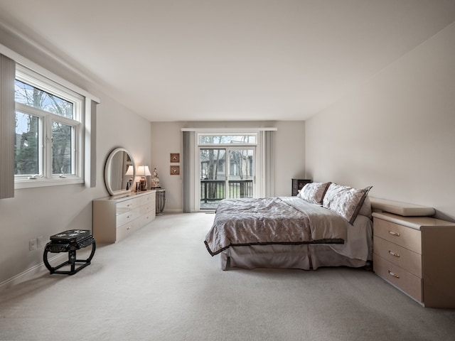 carpeted bedroom featuring access to outside