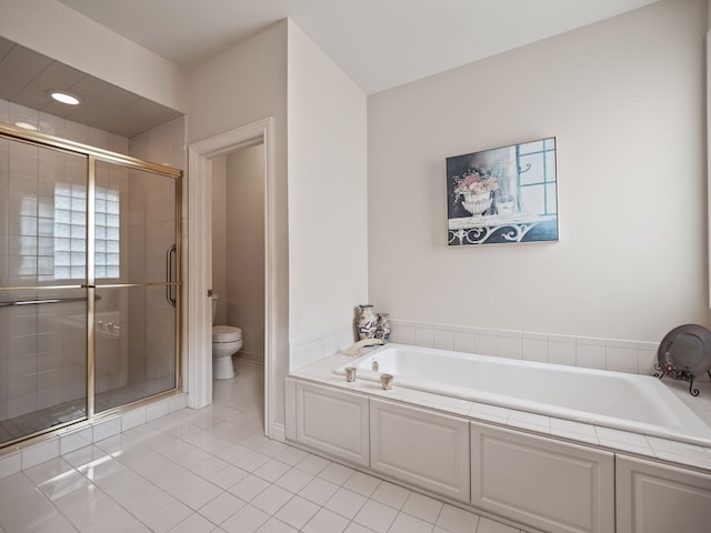bathroom with toilet, a bath, tile patterned flooring, and a stall shower