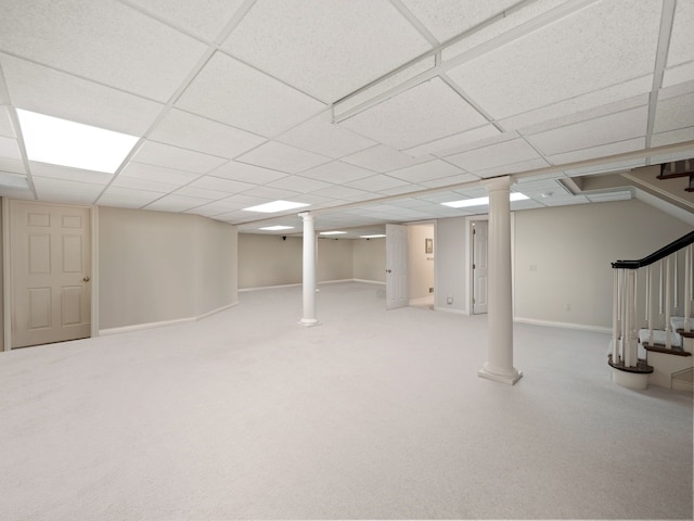 finished below grade area with carpet flooring, baseboards, and stairway
