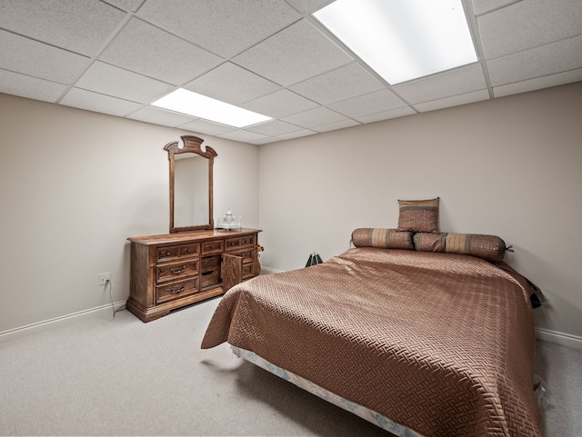 bedroom featuring a paneled ceiling, baseboards, and carpet floors