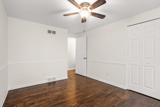 unfurnished bedroom featuring wood finished floors, baseboards, and visible vents