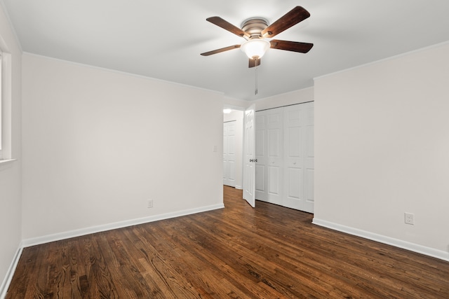 unfurnished bedroom with dark wood-type flooring, baseboards, and ornamental molding
