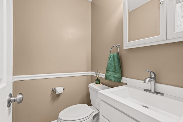 bathroom with toilet and vanity