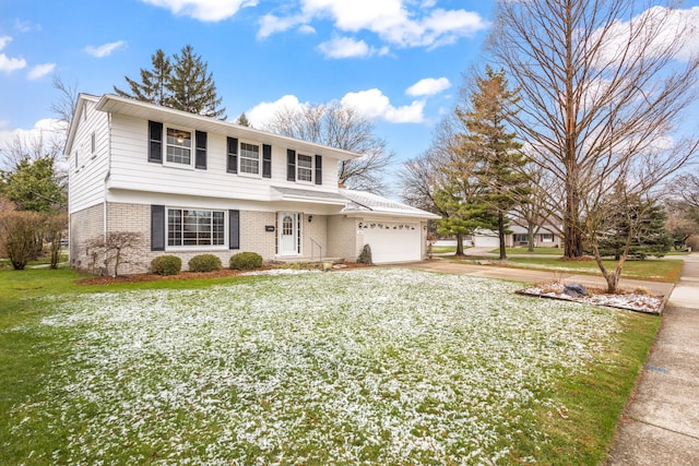 traditional home with brick siding, an attached garage, driveway, and a front lawn