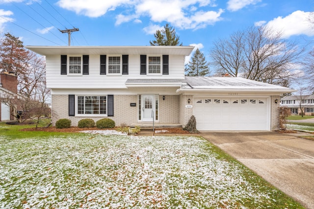 traditional-style house with brick siding, an attached garage, and driveway