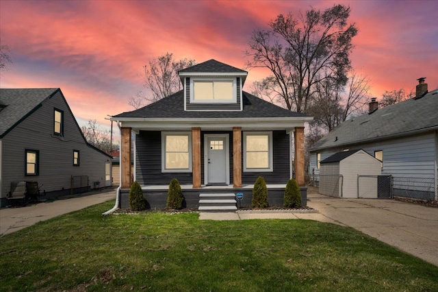 11393 Fisher Ave, Warren, MI 48089 - bungalow with roof with shingles, a porch, and a front yard