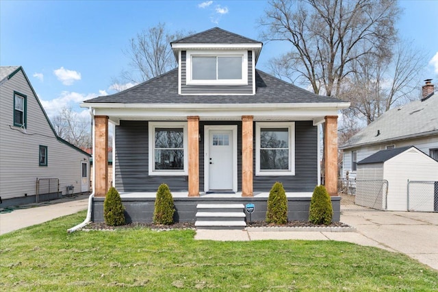 11393 Fisher Ave, Warren, MI 48089 - bungalow-style house with a front lawn, covered porch, and roof with shingles