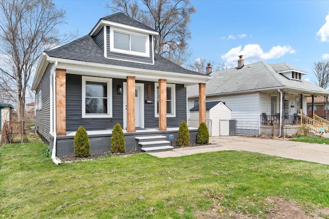 11393 Fisher Ave, Warren, MI 48089 - bungalow-style home featuring an outbuilding, a front lawn, covered porch, and roof with shingles