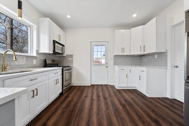 11393 Fisher Ave, Warren, MI 48089 - kitchen featuring gas range, tasteful backsplash, a sink, and dark wood-type flooring