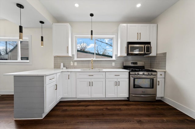 11393 Fisher Ave, Warren, MI 48089 - kitchen with stainless steel appliances, a sink, baseboards, backsplash, and white cabinetry
