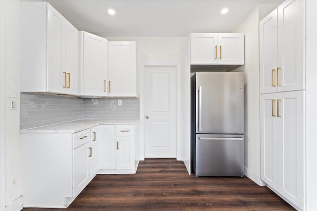 11393 Fisher Ave, Warren, MI 48089 - kitchen featuring backsplash, freestanding refrigerator, white cabinetry, and dark wood-style flooring