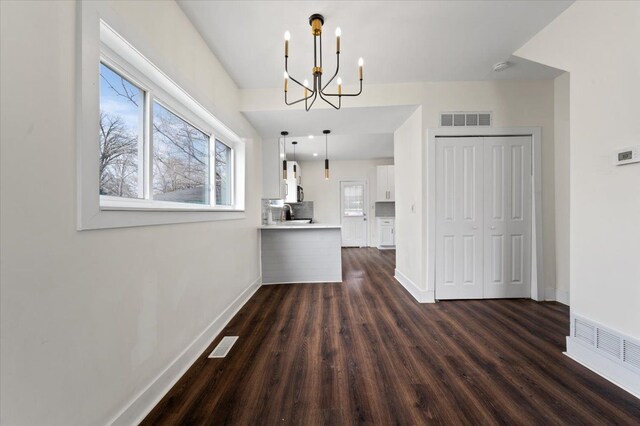 11393 Fisher Ave, Warren, MI 48089 - unfurnished dining area featuring dark wood finished floors, baseboards, and visible vents