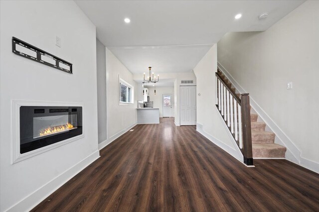 11393 Fisher Ave, Warren, MI 48089 - unfurnished living room featuring stairway, wood finished floors, a chandelier, baseboards, and visible vents