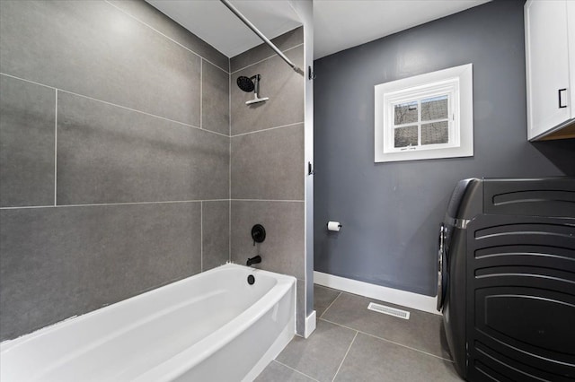 11393 Fisher Ave, Warren, MI 48089 - full bath with tile patterned flooring, shower / bathtub combination, visible vents, baseboards, and washer / clothes dryer