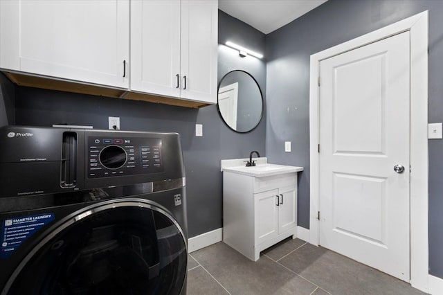 11393 Fisher Ave, Warren, MI 48089 - laundry area featuring a sink, cabinet space, baseboards, washer / clothes dryer, and dark tile patterned floors