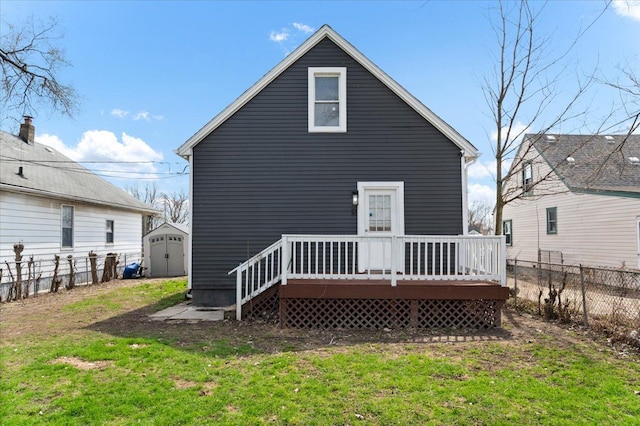 11393 Fisher Ave, Warren, MI 48089 - rear view of property featuring a fenced backyard, a wooden deck, an outbuilding, a lawn, and a storage unit