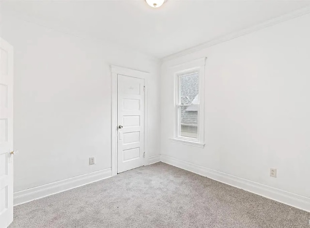 carpeted empty room with baseboards