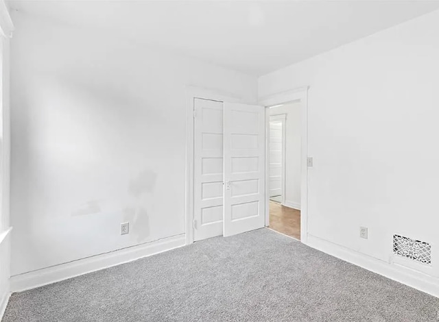 unfurnished bedroom featuring baseboards and carpet flooring