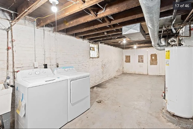 below grade area featuring a sink, gas water heater, and separate washer and dryer