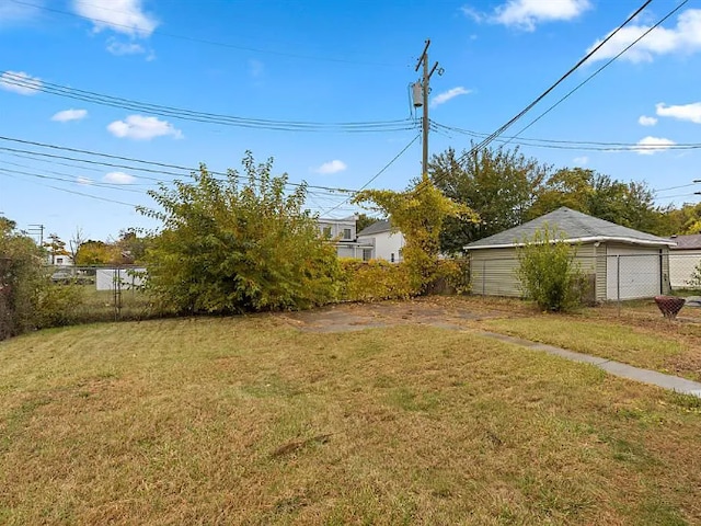 view of yard with fence and a detached garage