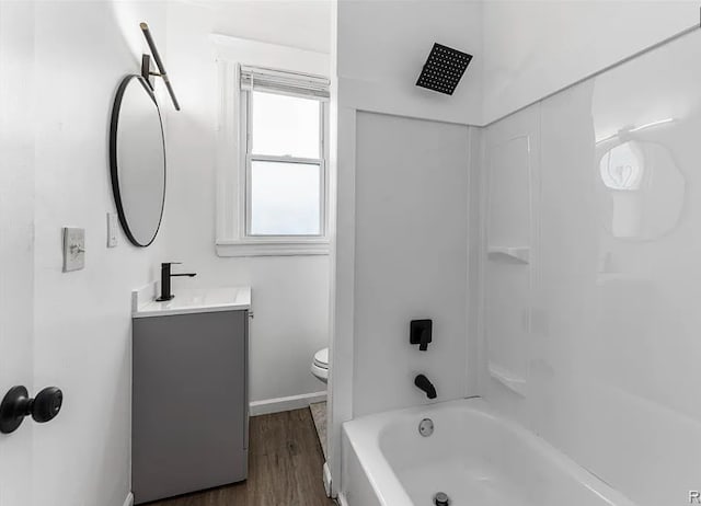 full bathroom with vanity, baseboards, toilet, shower / bathtub combination, and wood finished floors