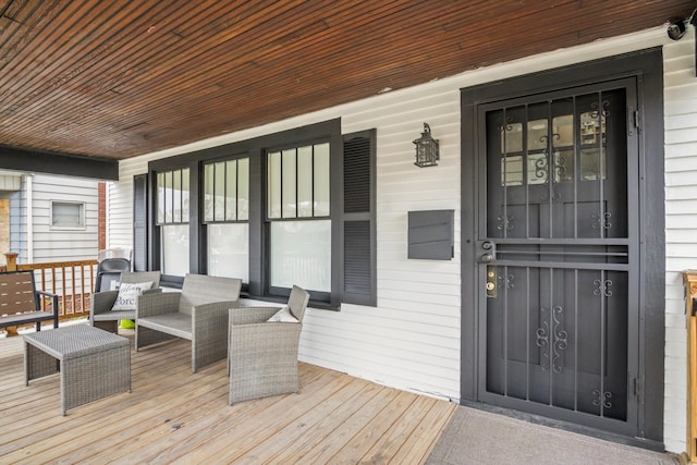wooden terrace featuring covered porch