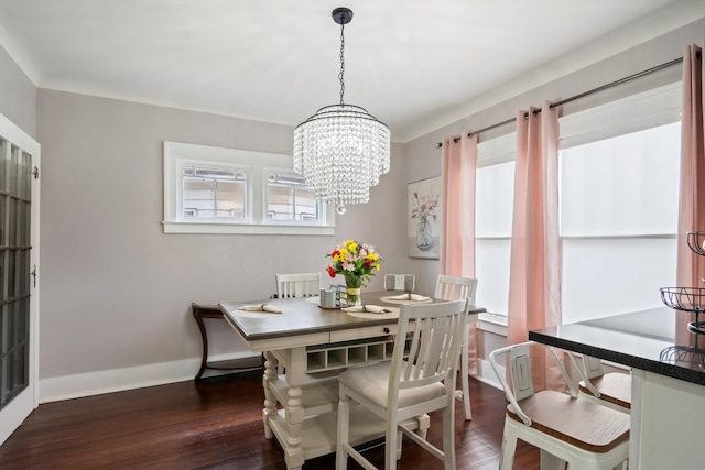 dining space with baseboards, an inviting chandelier, and dark wood finished floors
