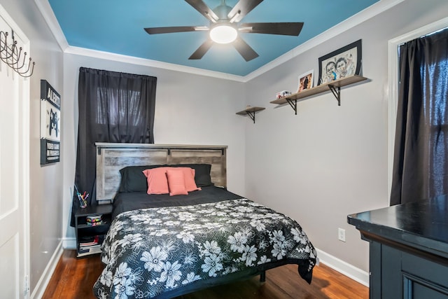 bedroom with wood finished floors, ceiling fan, baseboards, and ornamental molding
