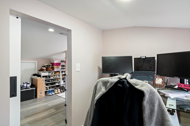 office with recessed lighting, visible vents, wood finished floors, and lofted ceiling