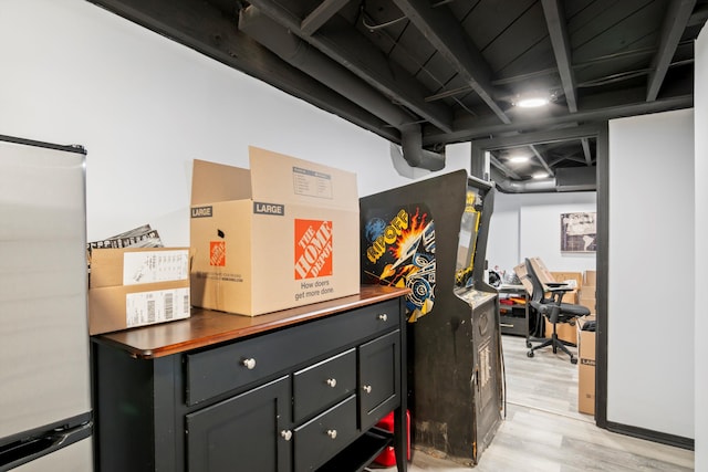 interior space featuring light wood-style floors and freestanding refrigerator