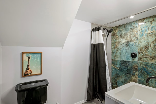 bathroom with a sink, baseboards, and curtained shower