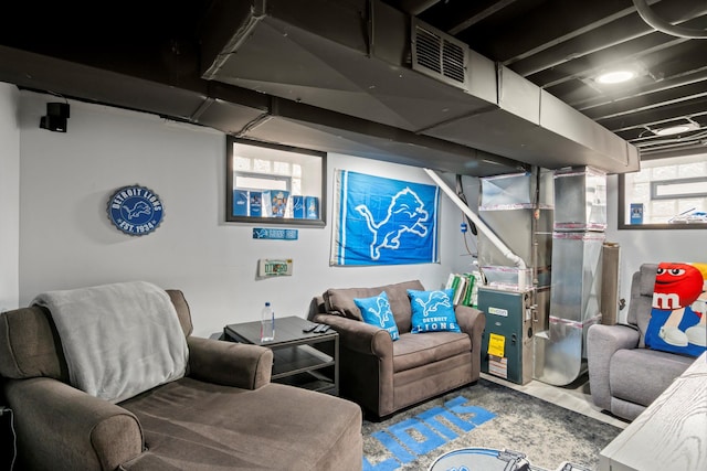 living area featuring visible vents and heating unit