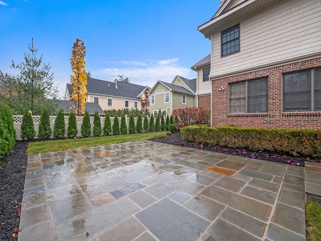 view of patio with a residential view and fence