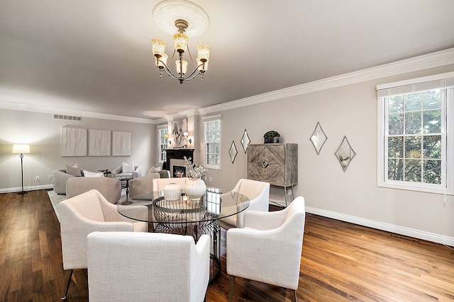dining area with ornamental molding, visible vents, a notable chandelier, and a healthy amount of sunlight