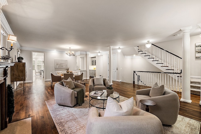 living room with stairway, dark wood-style flooring, ornate columns, and crown molding