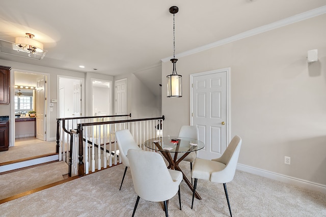 dining room with light colored carpet, baseboards, ornamental molding, and recessed lighting