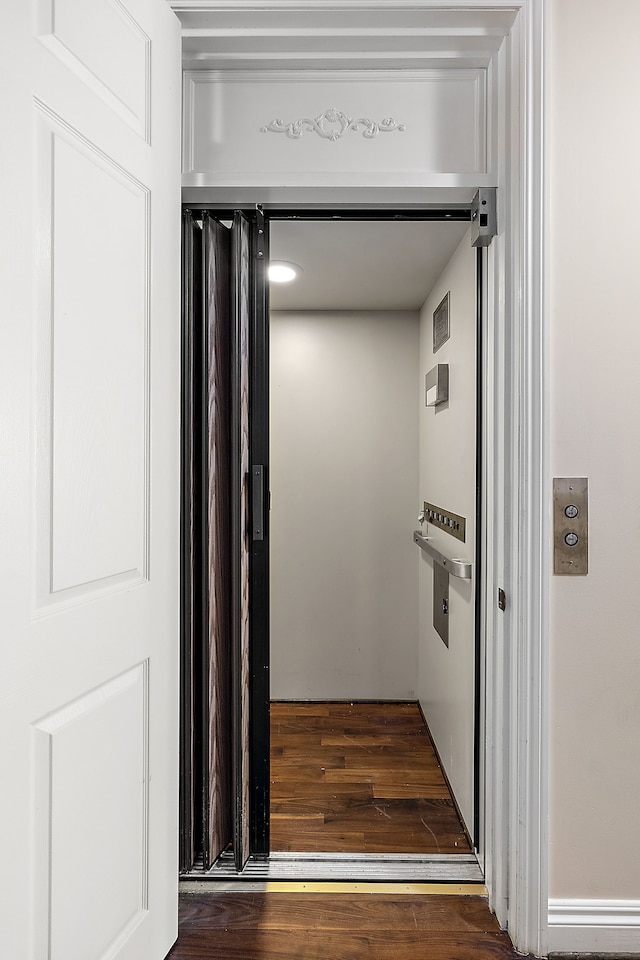 interior details with elevator and wood finished floors