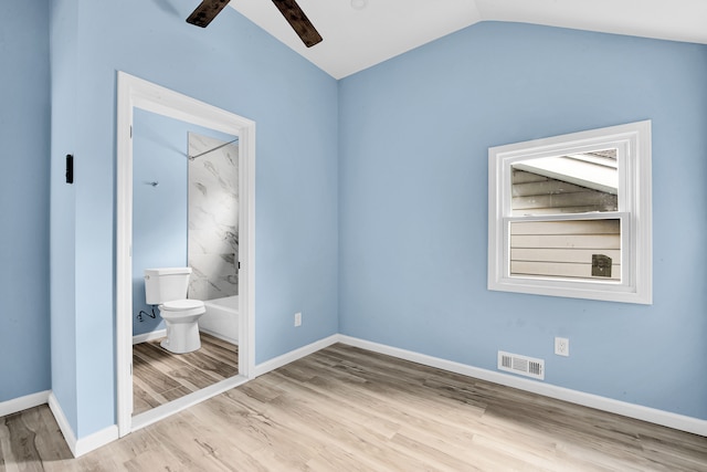 2533 Virginia Park St, Detroit, MI 48206 - unfurnished bedroom featuring visible vents, baseboards, ensuite bathroom, vaulted ceiling, and wood finished floors