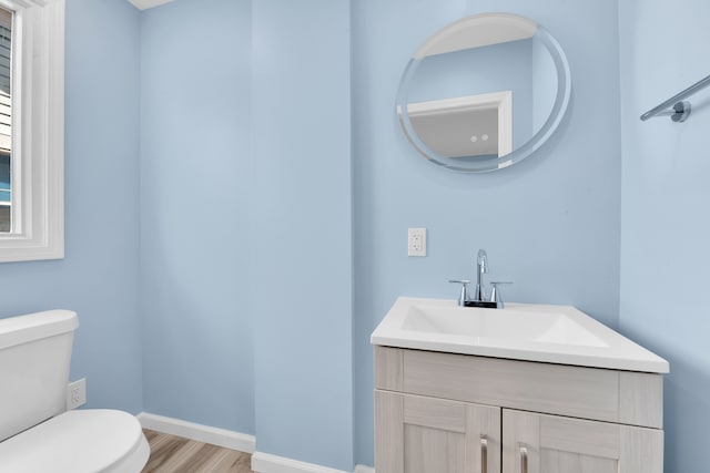 2533 Virginia Park St, Detroit, MI 48206 - bathroom featuring toilet, vanity, wood finished floors, and baseboards