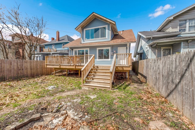 2533 Virginia Park St, Detroit, MI 48206 - back of property featuring roof with shingles, a wooden deck, and fence