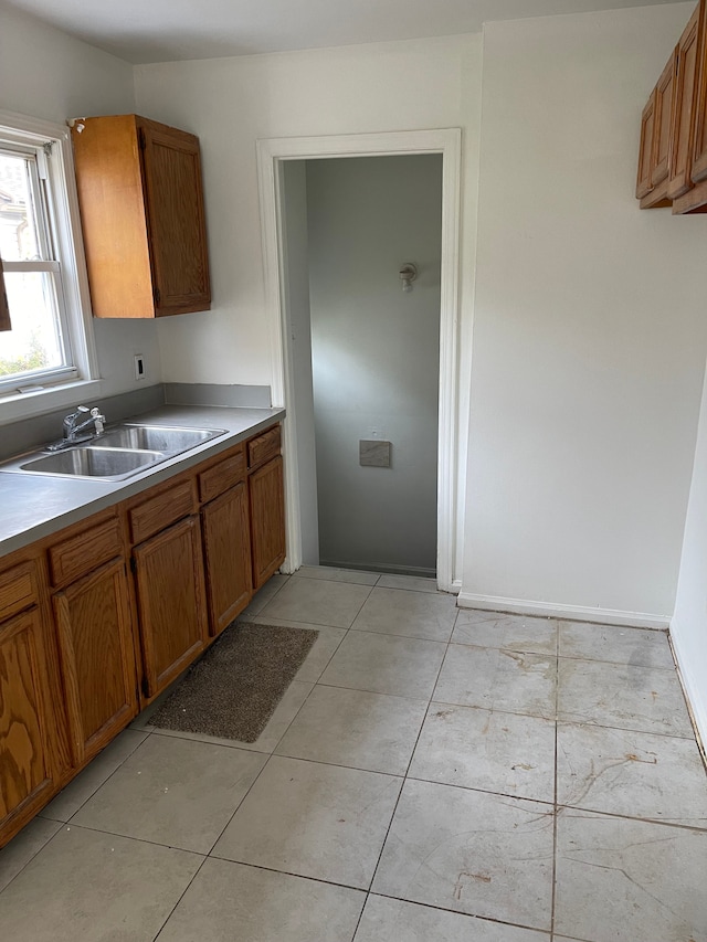 305 S Blvd W, Pontiac, MI 48341 - kitchen featuring a sink, brown cabinetry, and light countertops