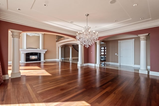 82 Chateaux Du Lac, Fenton, MI 48430 - unfurnished dining area with crown molding, arched walkways, a glass covered fireplace, and wood finished floors